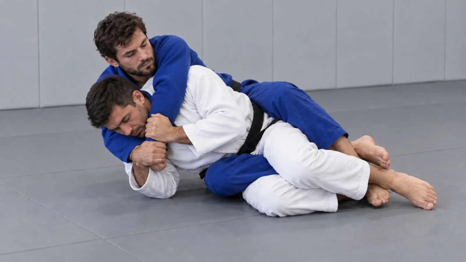 Sliding down towards the choking-arm side to bring the shoulders onto the mat.