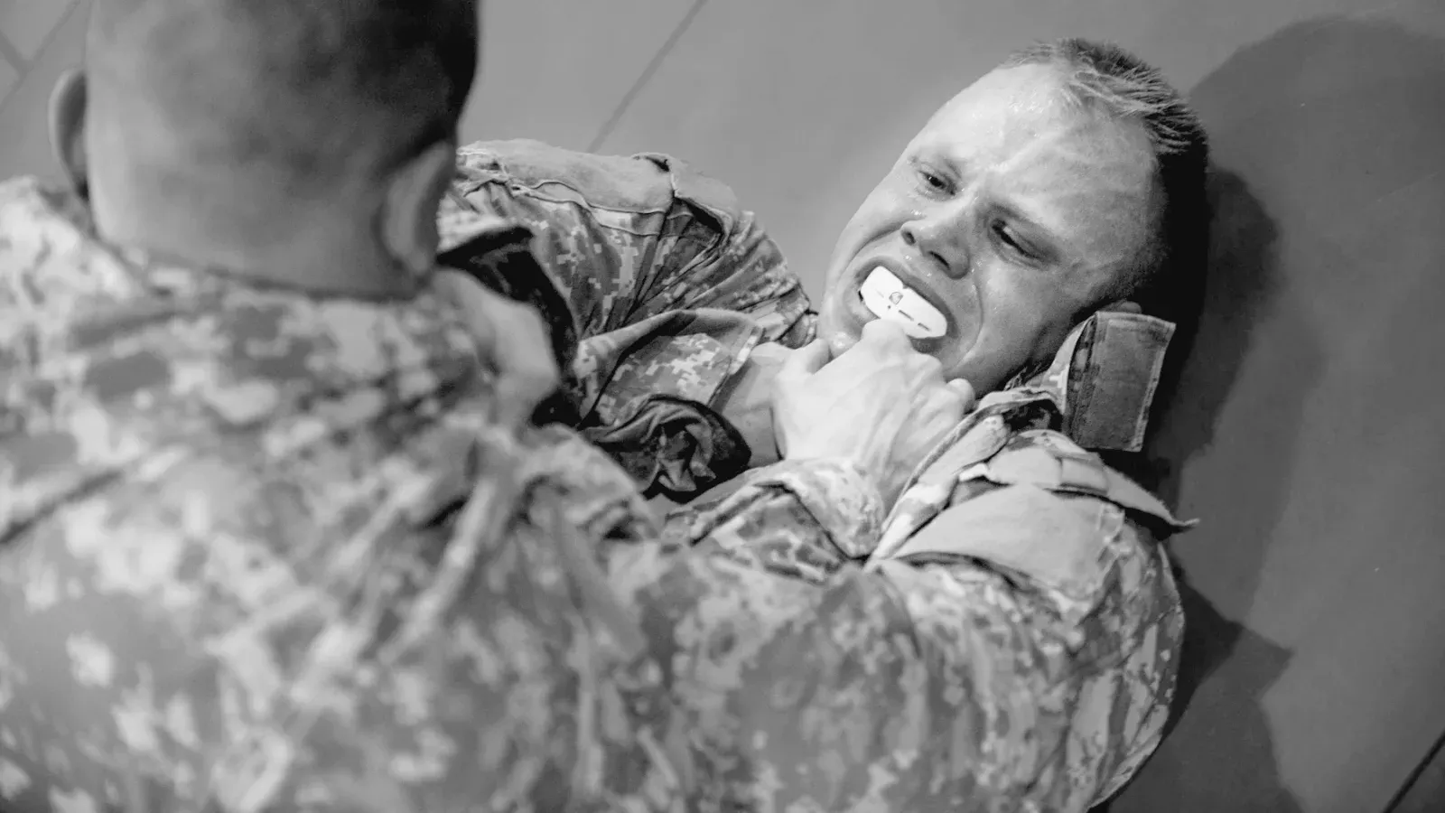 Brazilian Jiu Jitsu practitioners best warrior soldiers battle during combatives while training on the mat.