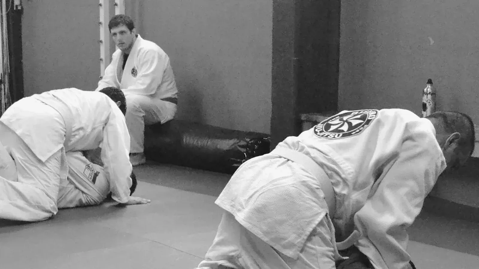 Brazilian Jiu Jitsu practitioners gi positional training while training on the mat.