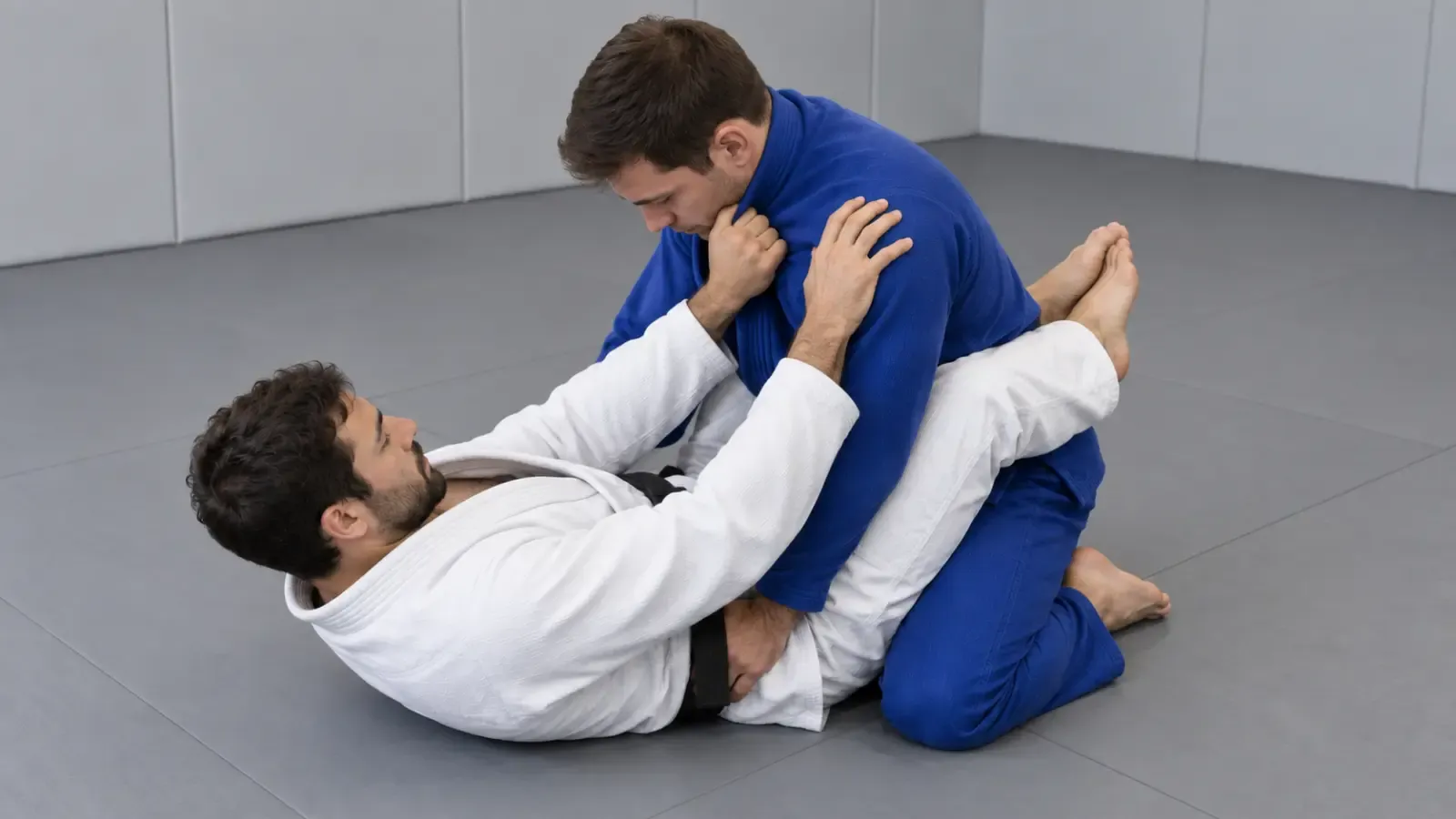 A guard player taking a deep first grip on the opponent’s collar with the thumb inside.