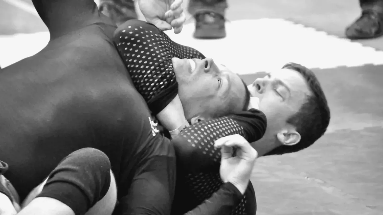Brazilian Jiu Jitsu practitioners no gi ground position while training on the mat.