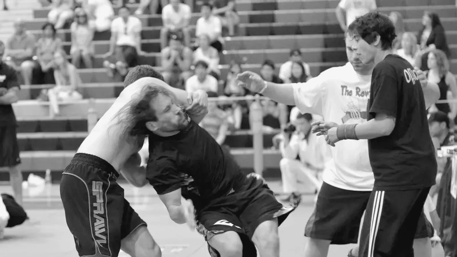 Brazilian Jiu Jitsu practitioners no gi standing competition while training on the mat.
