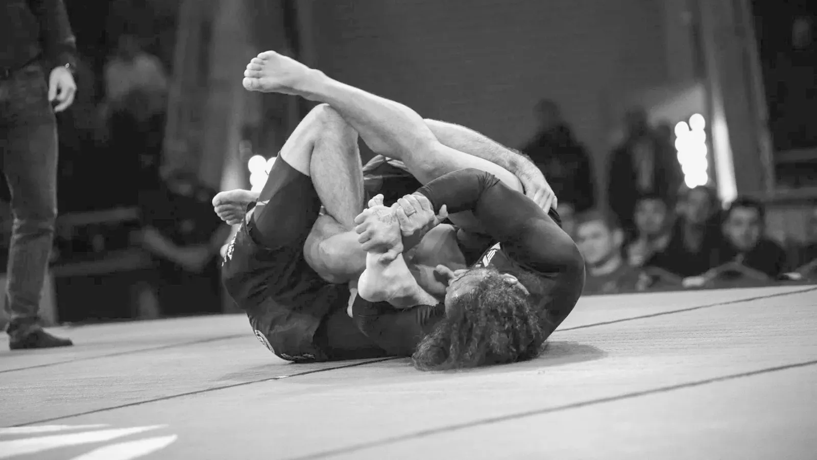 Brazilian Jiu Jitsu practitioners no gi submission attempt while training on the mat.