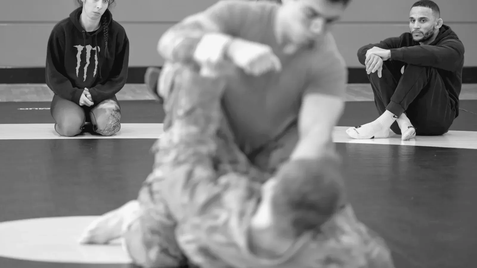 Brazilian Jiu Jitsu practitioners past while training on the mat.