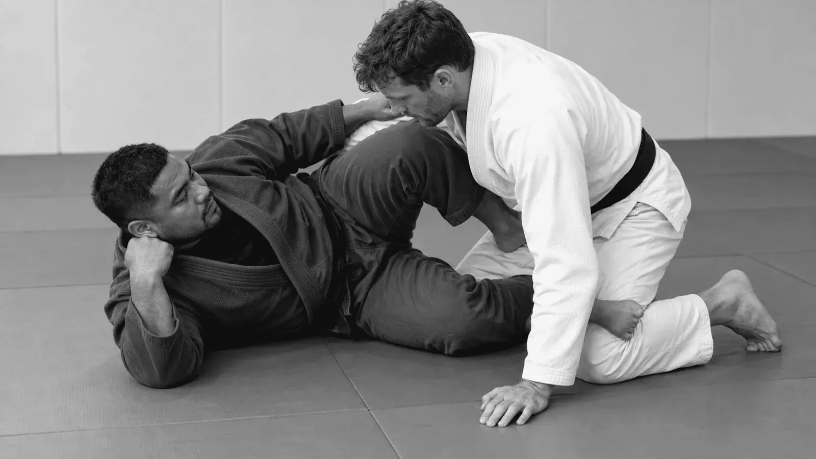 Gi partners working on knee-shield frames from half guard.