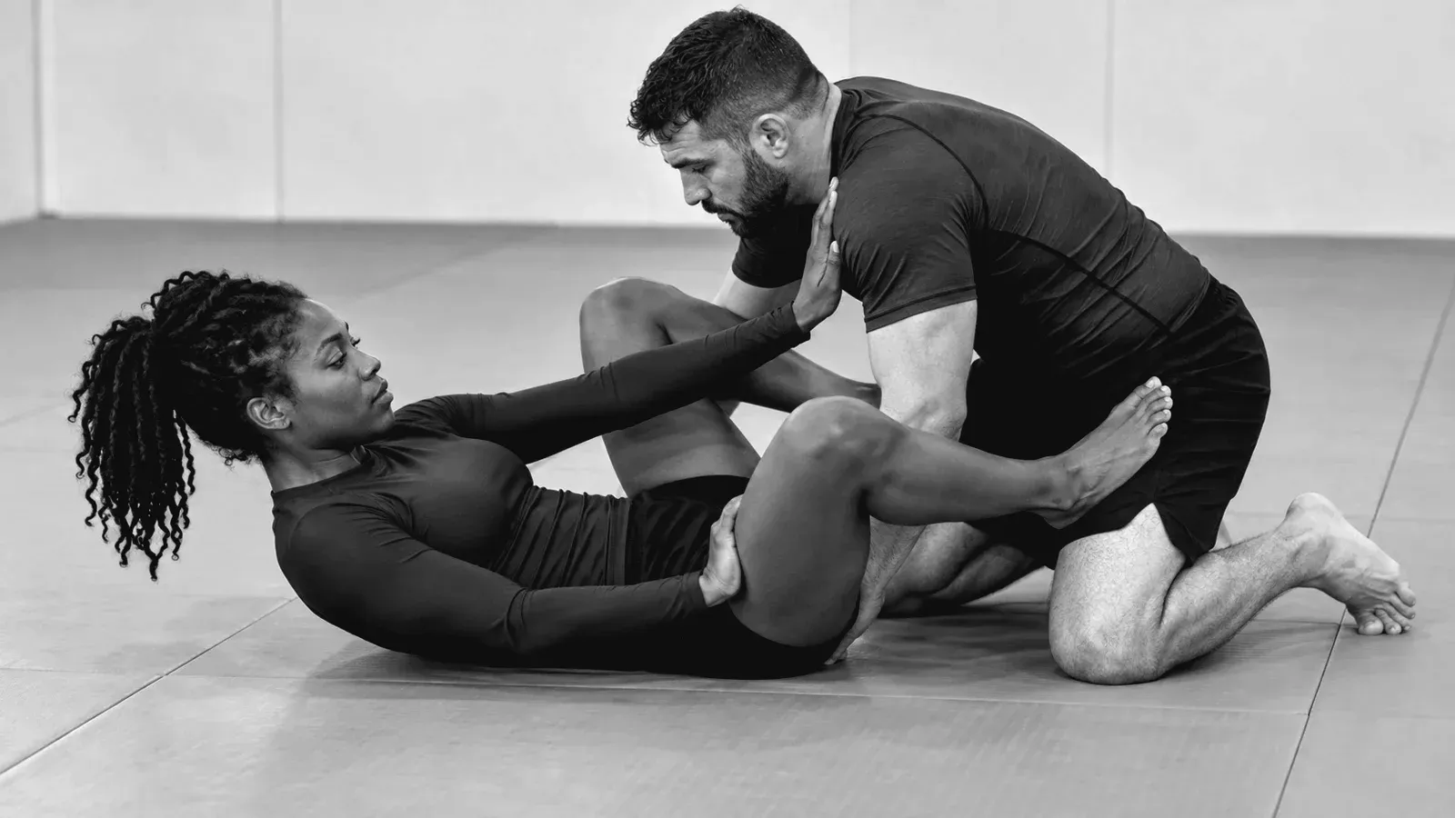 No-gi partners working on guard retention with frames at the hips.