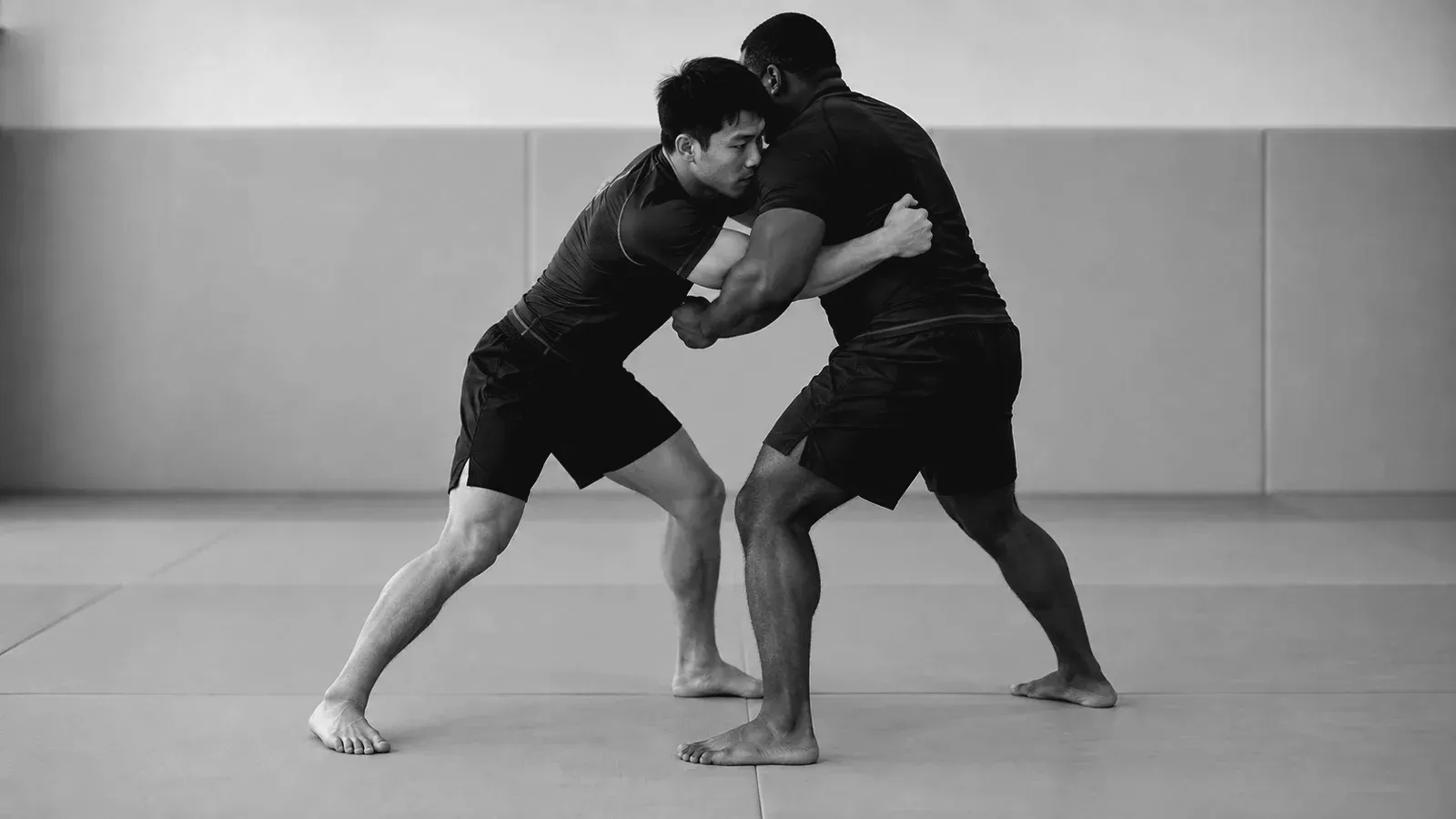 No-gi partners hand-fighting with an underhook in a standing clinch.