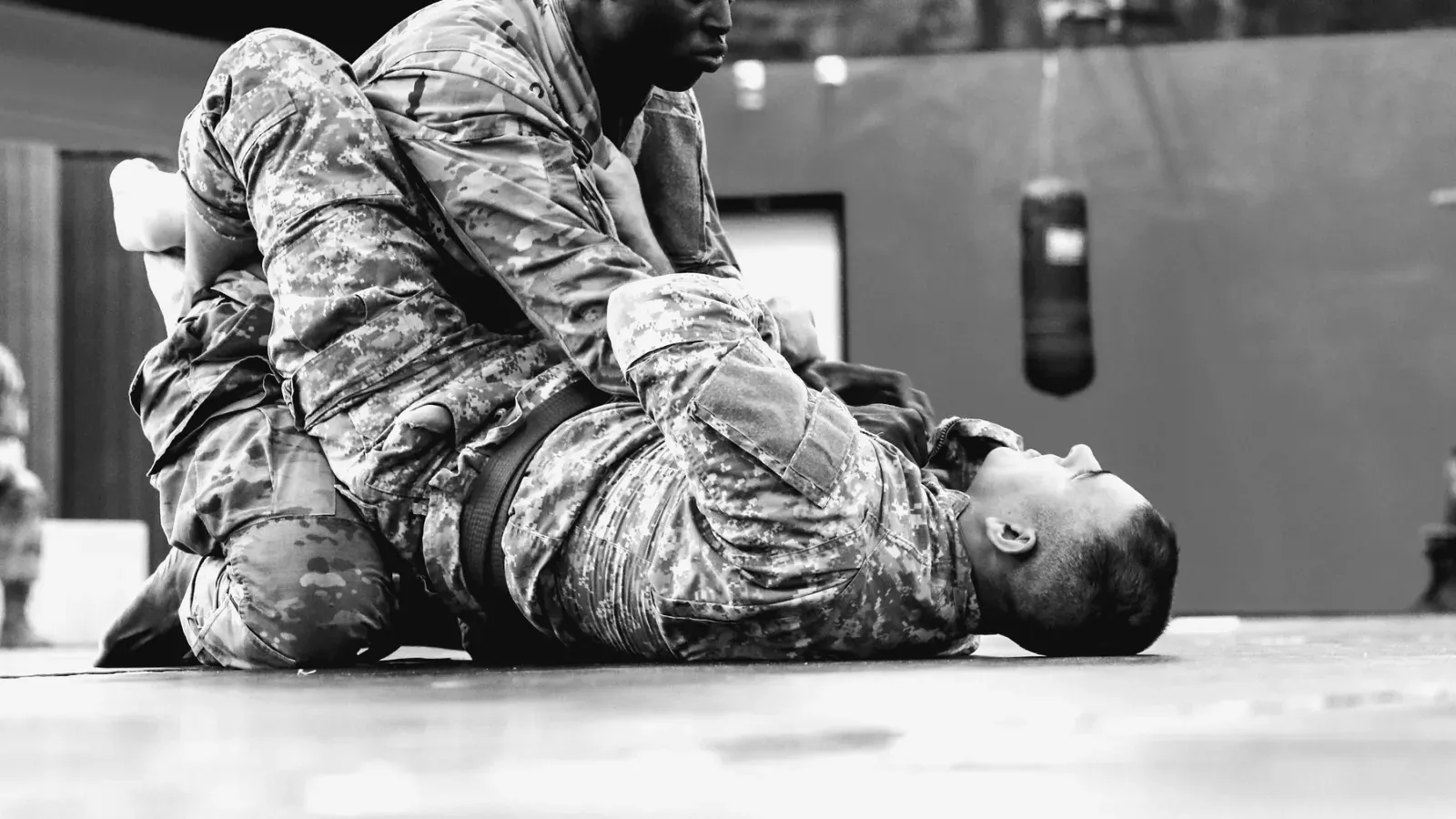 Brazilian Jiu Jitsu practitioners lrmc combatives rallies soldier lethality while training on the mat.
