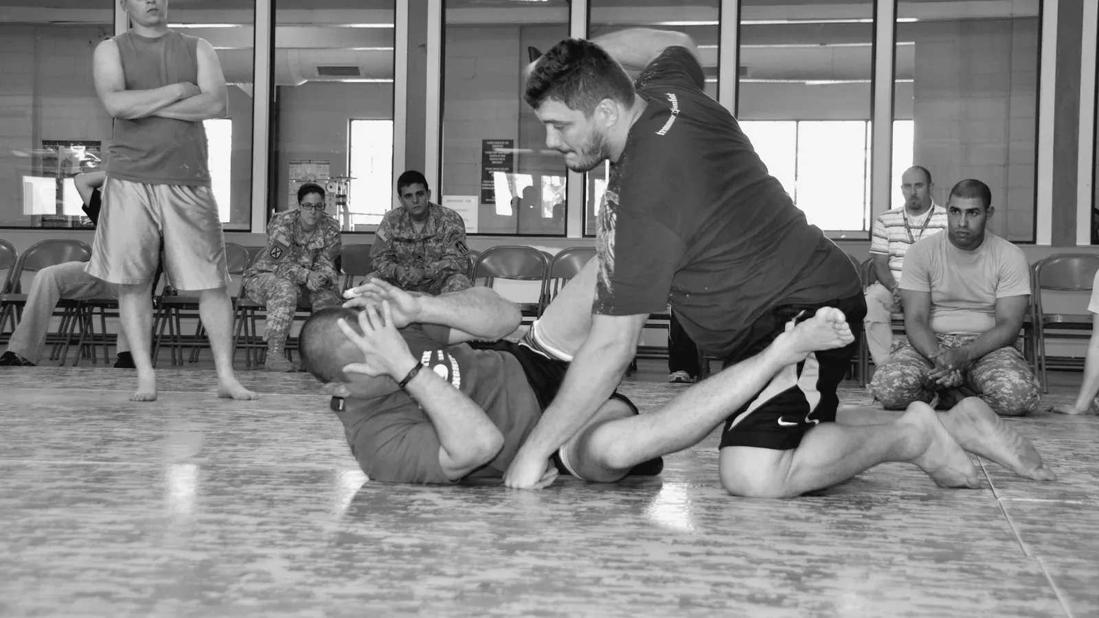 Brazilian Jiu Jitsu practitioners matt mitrione chris lytle demonstrate fighting while training on the mat.